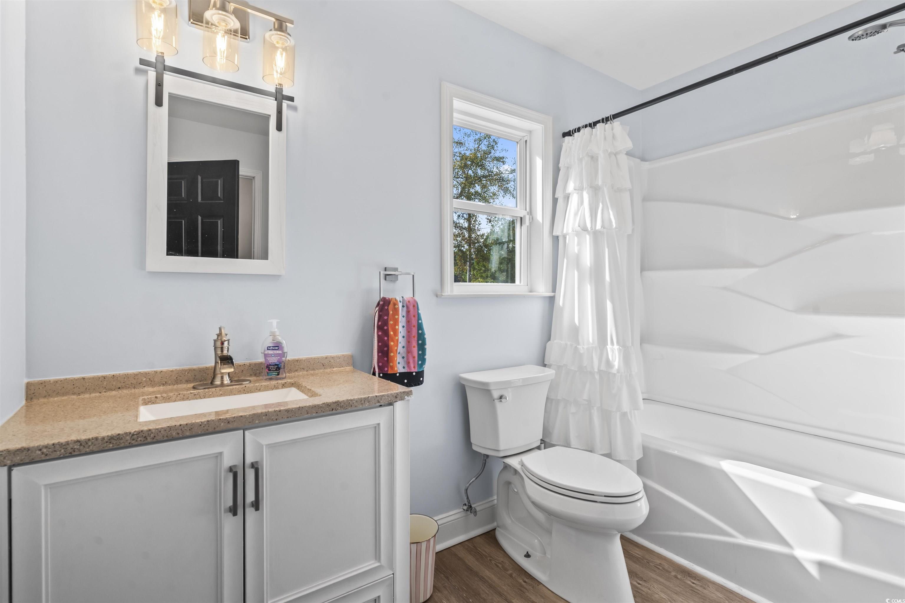 1495 Wilderness Lane Loris, SC 29569 - Photo 12 of 37 Bathroom with vanity, shower / bath combo with shower curtain, and wood finished floors