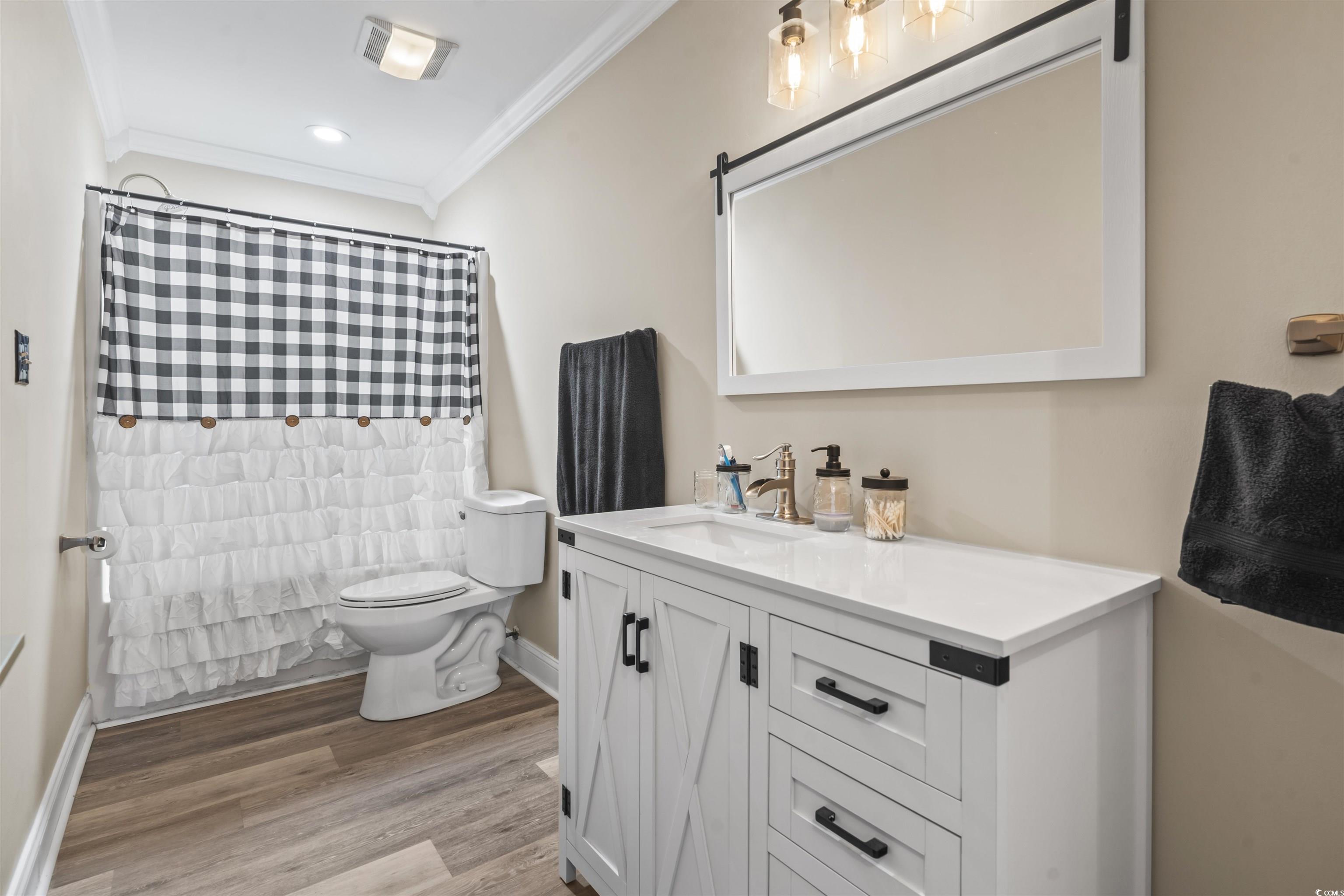 1495 Wilderness Lane Loris, SC 29569 - Photo 17 of 37 Full bathroom featuring curtained shower, vanity, crown molding, light wood-type flooring, and recessed lighting