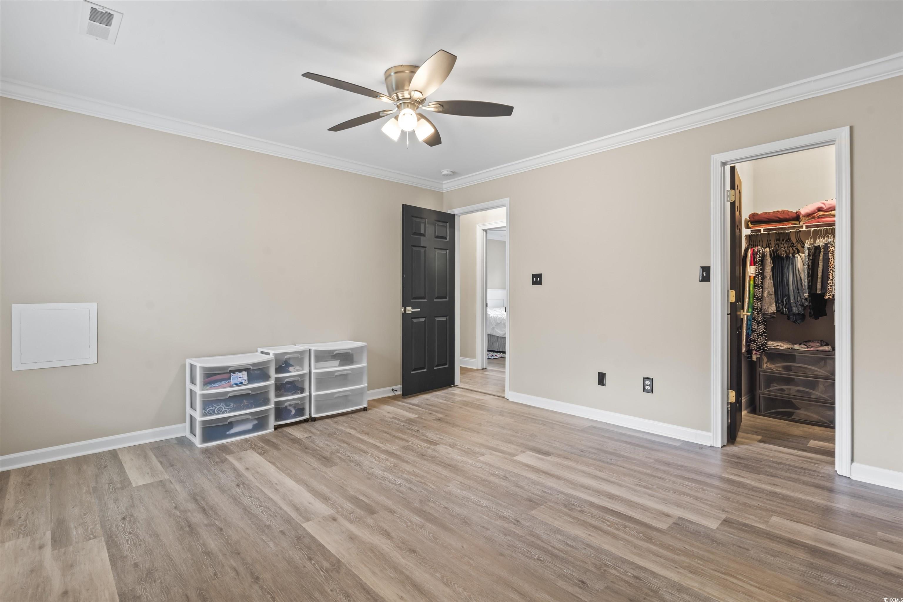 1495 Wilderness Lane Loris, SC 29569 - Photo 21 of 37 Unfurnished room featuring crown molding, light wood finished floors, and a ceiling fan