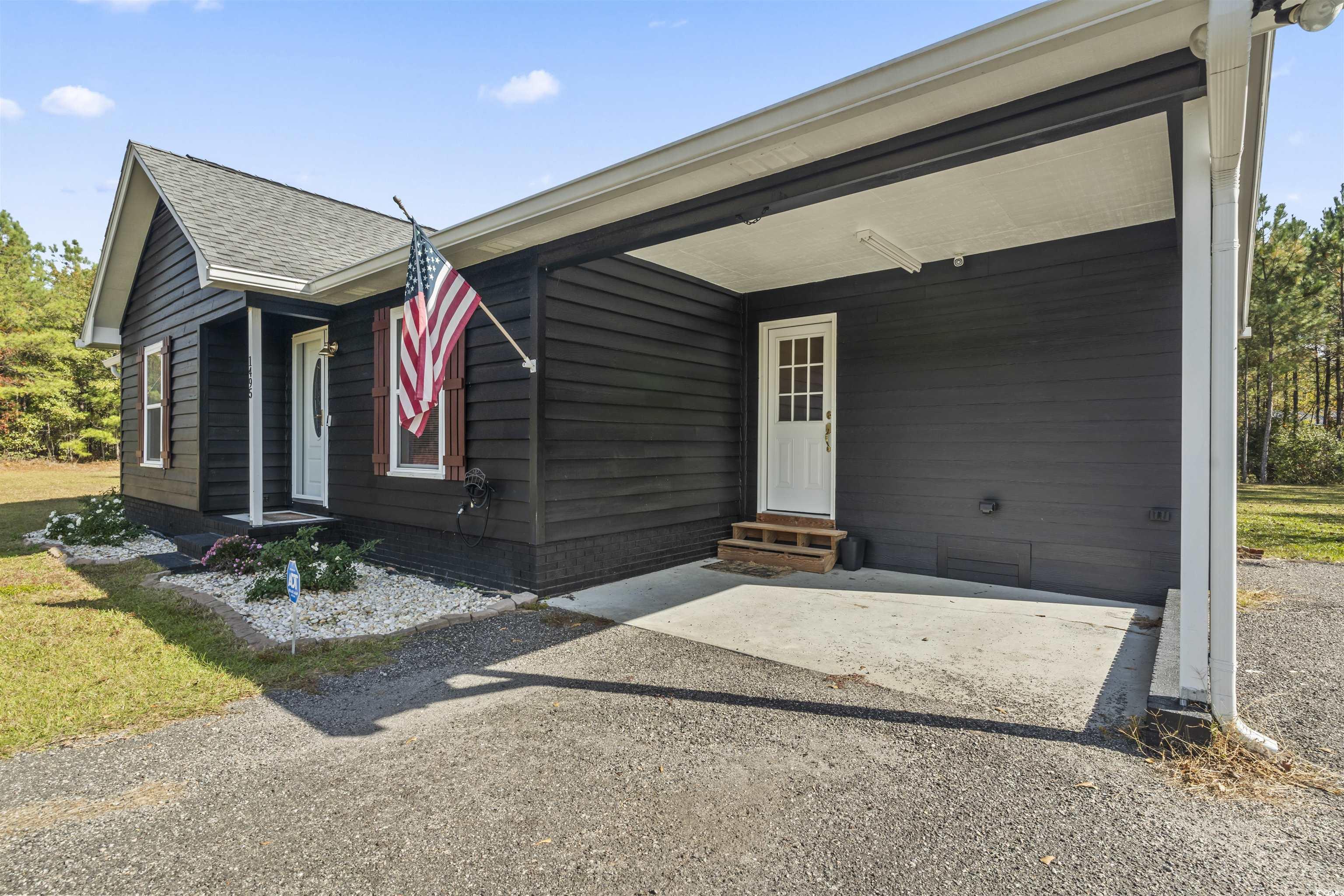 1495 Wilderness Lane Loris, SC 29569 - Photo 3 of 37 View of front facade with entry steps and a front yard