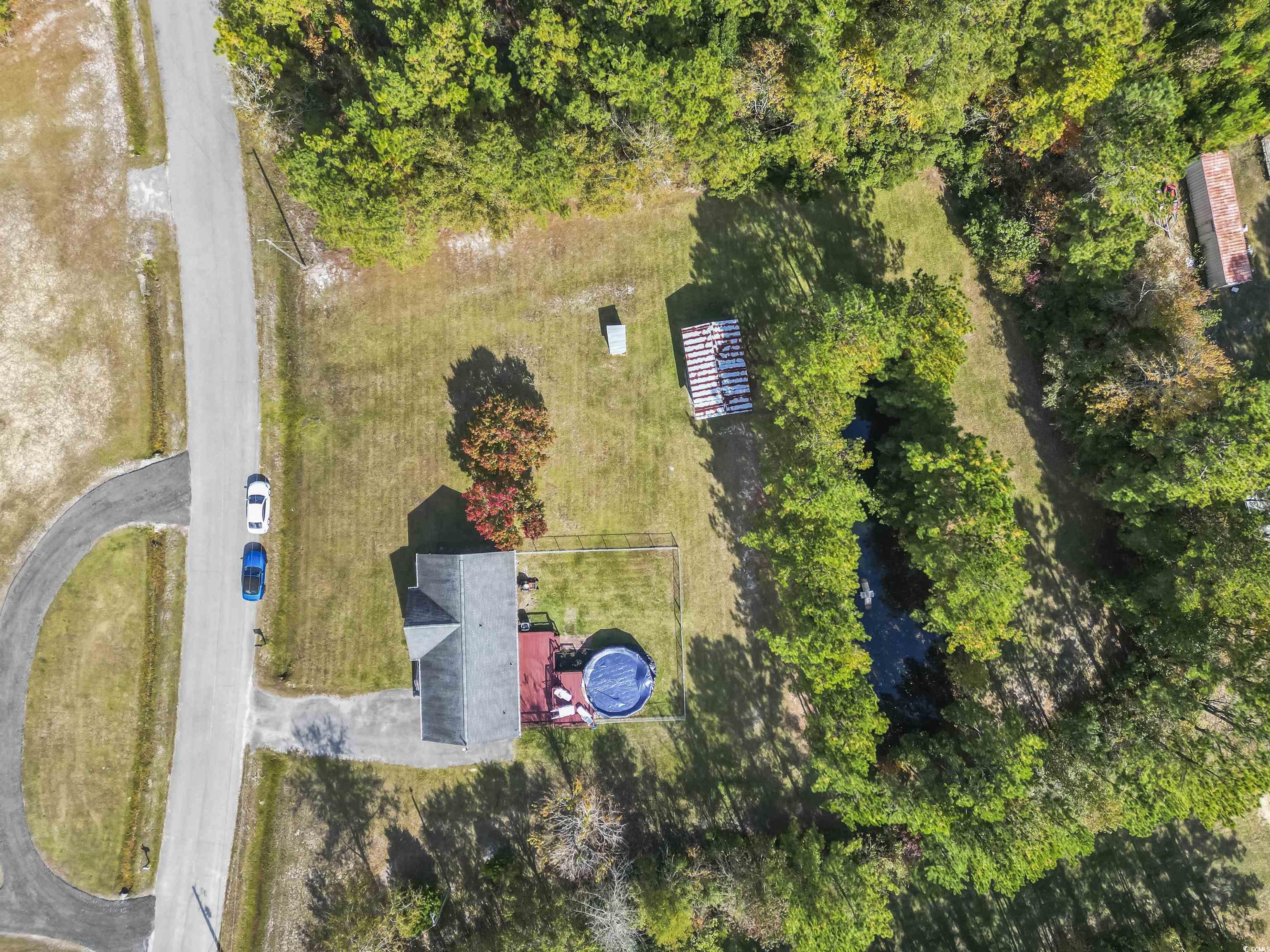 1495 Wilderness Lane Loris, SC 29569 - Photo 35 of 37 View of subject property featuring a heavily wooded area