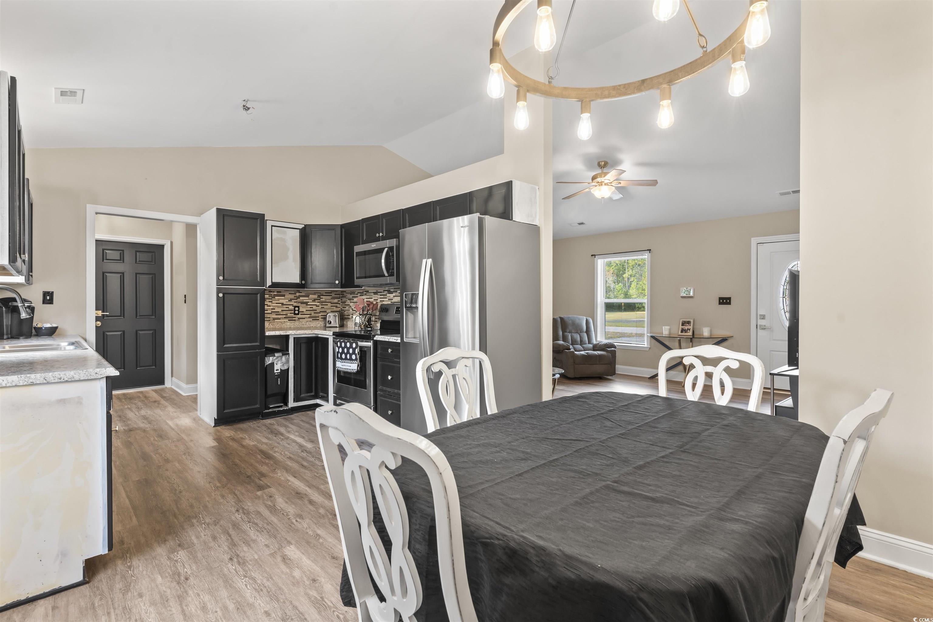 1495 Wilderness Lane Loris, SC 29569 - Photo 4 of 37 Dining area featuring vaulted ceiling and light wood-type flooring