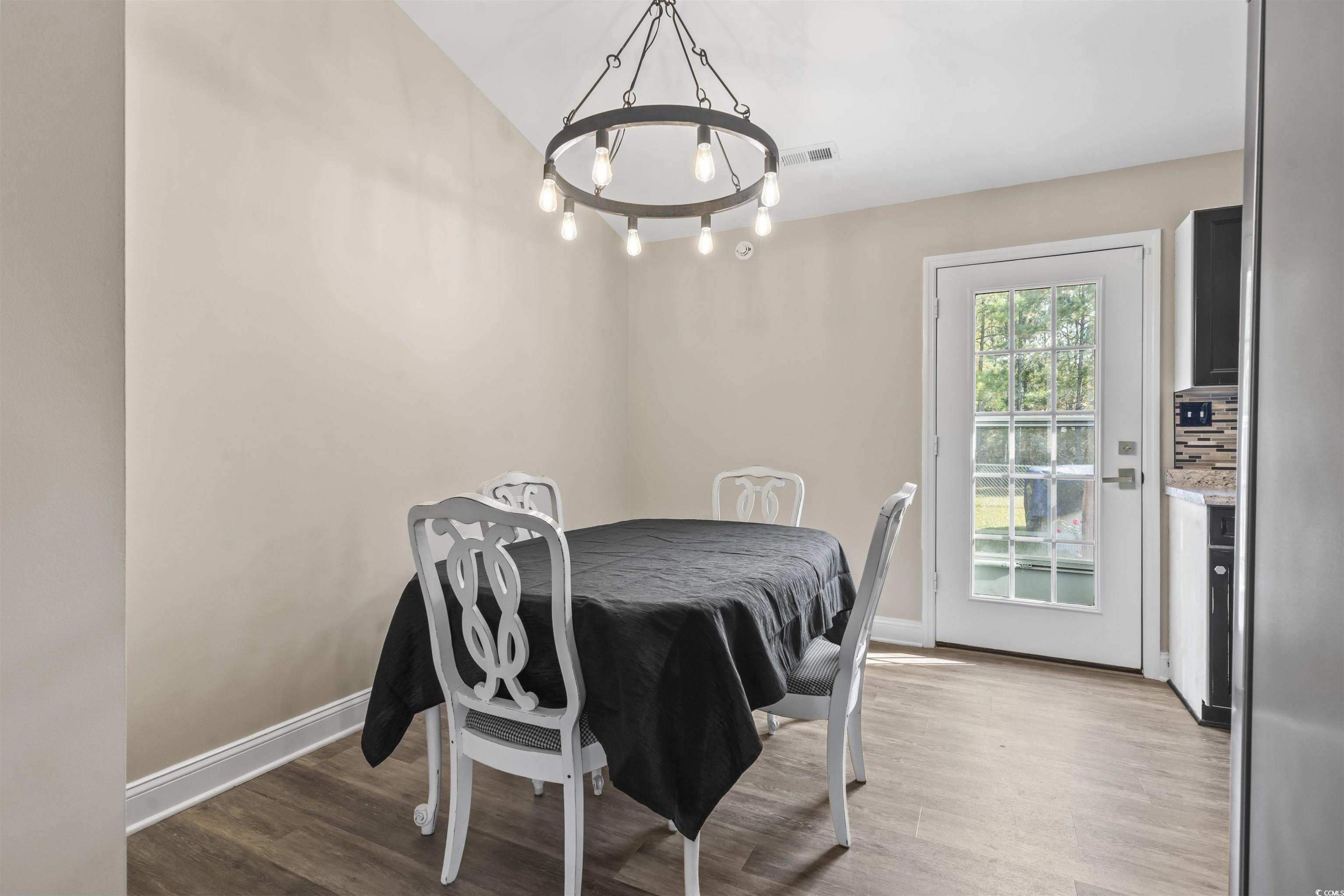 1495 Wilderness Lane Loris, SC 29569 - Photo 8 of 37 Dining area featuring light wood-style floors and a chandelier