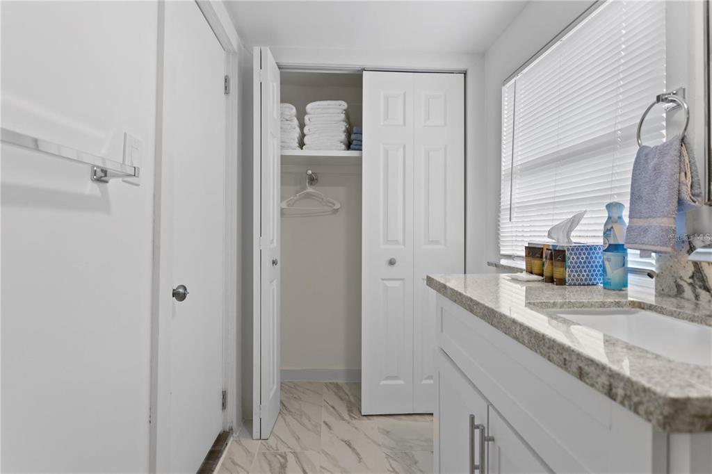 904 Lakeview Road, Unit A Clearwater, FL 33756 - Photo 11 of 25 a bathroom with a granite countertop sink and a mirror