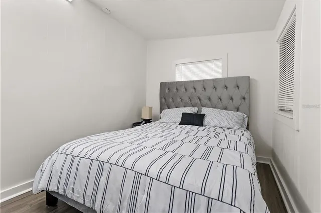 a bedroom with a bed and a night stand