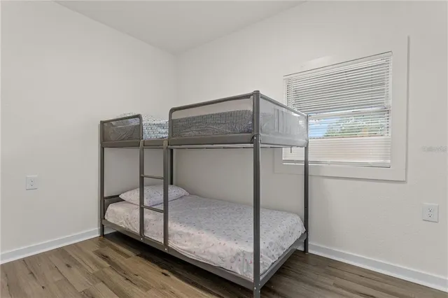 a room that has a bed and a table in it