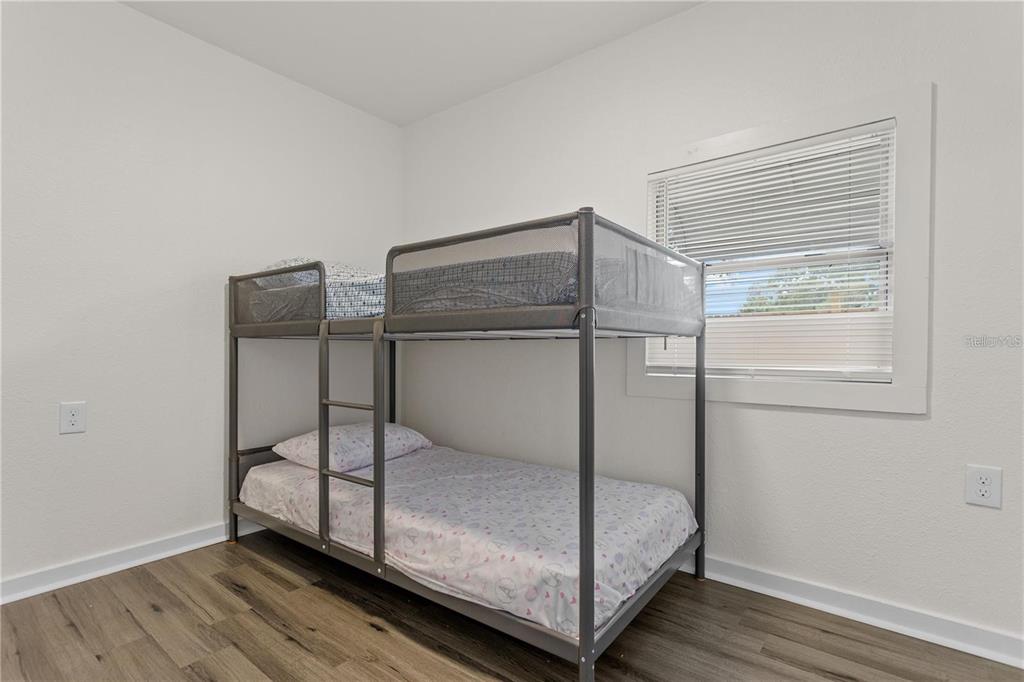 904 Lakeview Road, Unit A Clearwater, FL 33756 - Photo 15 of 25 a room that has a bed and a table in it