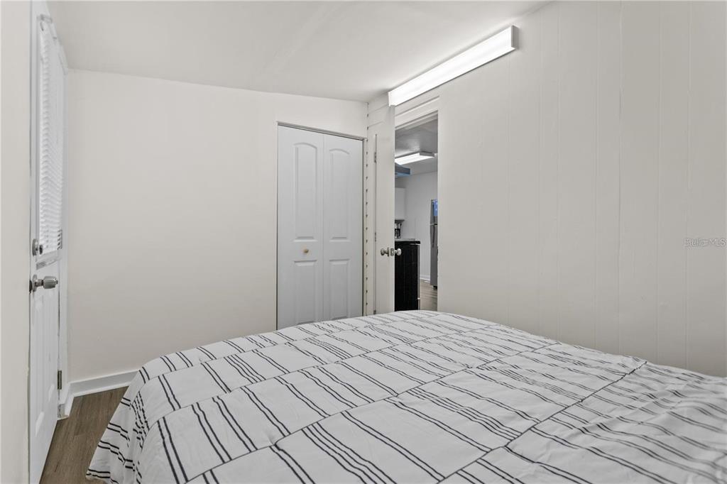 904 Lakeview Road, Unit A Clearwater, FL 33756 - Photo 16 of 25 a bedroom with a bed and a mirror