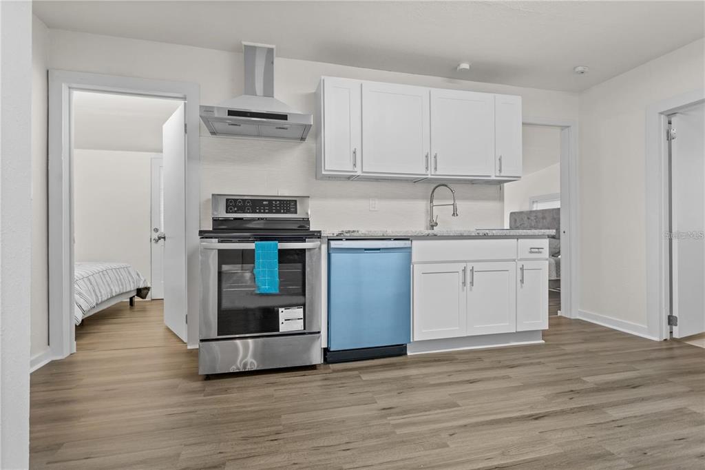 904 Lakeview Road, Unit A Clearwater, FL 33756 - Photo 17 of 25 a kitchen with stainless steel appliances granite countertop a stove and a refrigerator