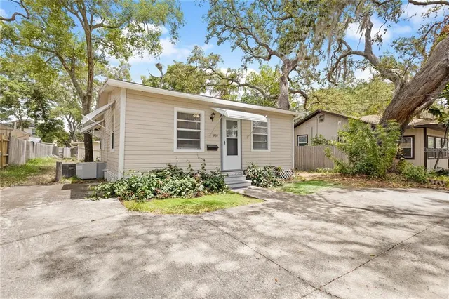 a front view of a house with a yard and a glass top table