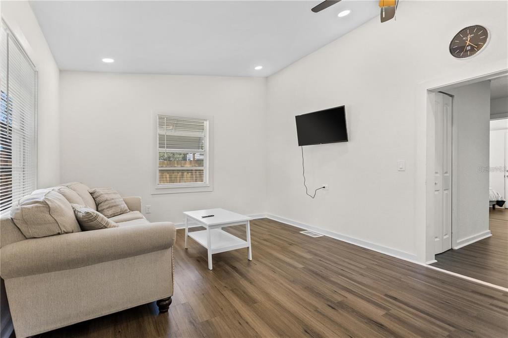 904 Lakeview Road, Unit A Clearwater, FL 33756 - Photo 21 of 25 a living room with furniture and a flat screen tv