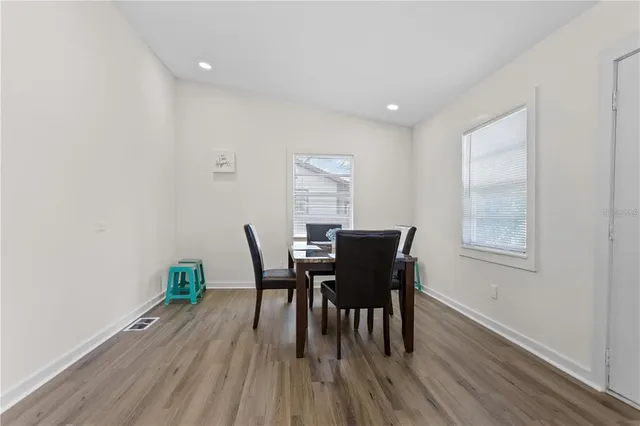 a view of a dining room with furniture and wooden floor