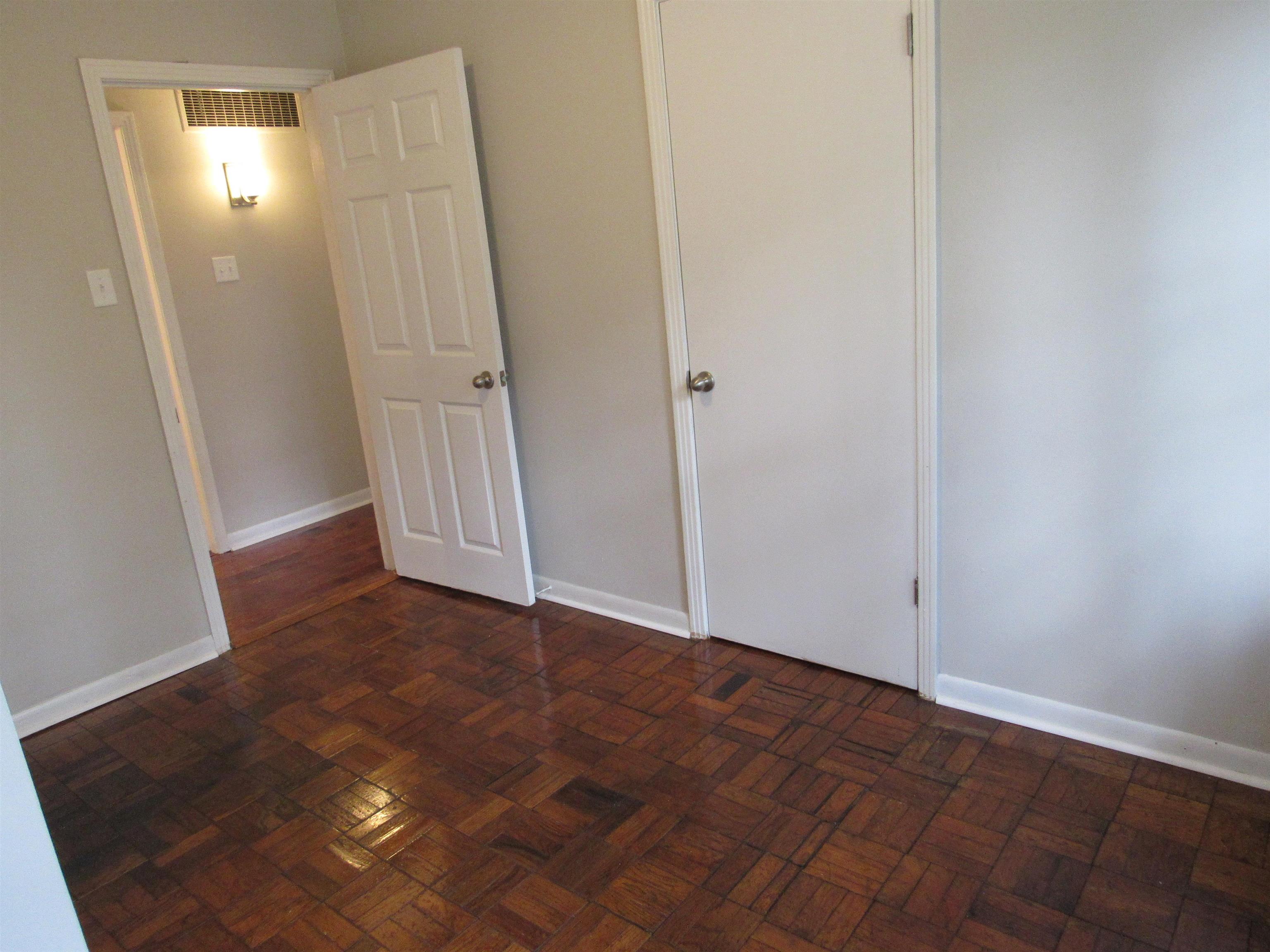 5055 Wingdale Road Memphis, TN 38117 - Photo 16 of 20 Unfurnished bedroom with parquet flooring and baseboards