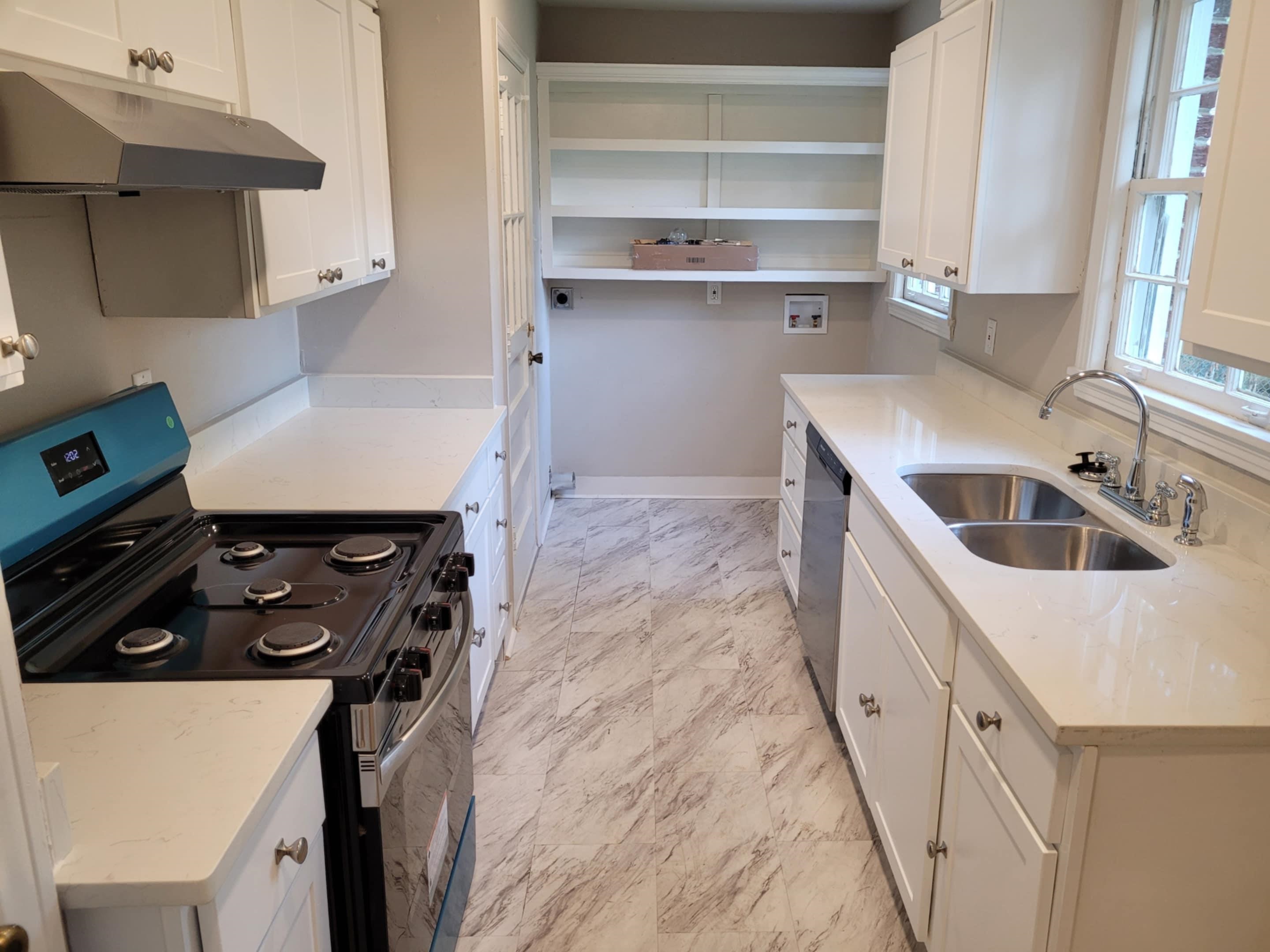 5055 Wingdale Road Memphis, TN 38117 - Photo 6 of 20 Kitchen with black range with electric cooktop, white cabinetry, light marble finish flooring, and light stone counters