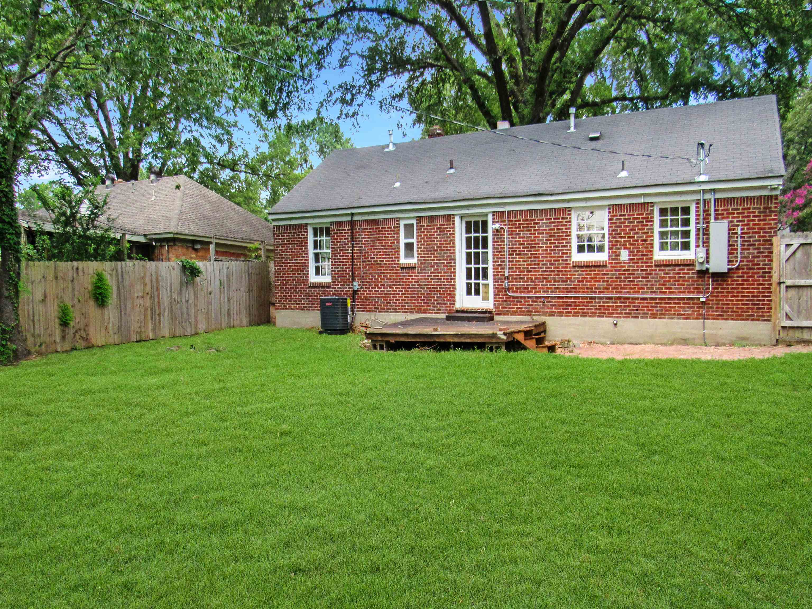 5055 Wingdale Road Memphis, TN 38117 - Photo 8 of 20 Rear view of property featuring a fenced backyard, a wooden deck, brick siding, and crawl space