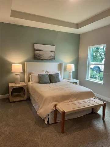 a bedroom with a bed and window