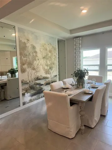 a living room with fireplace furniture and a large window