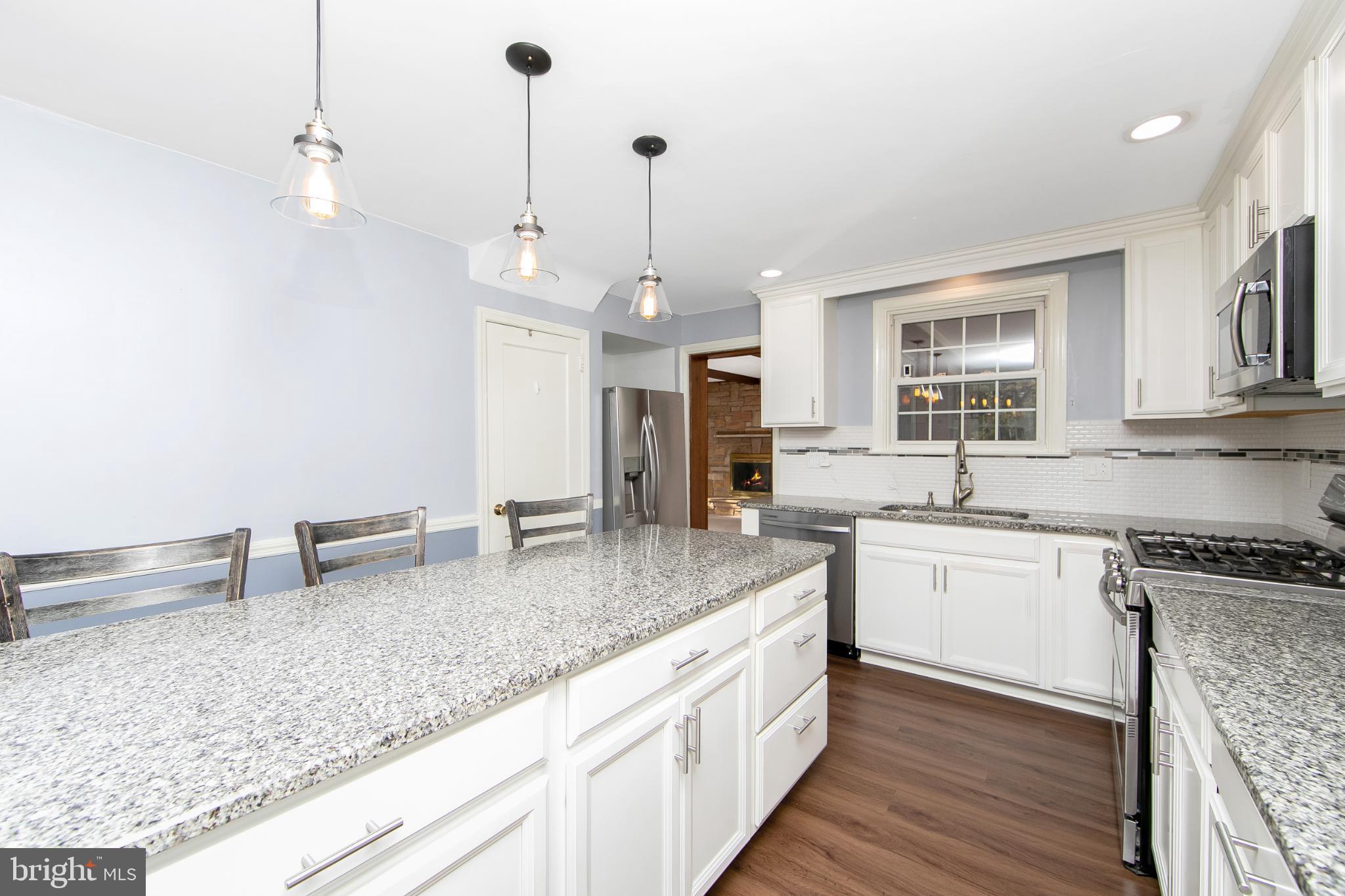 414 Stanfield Road Springfield, PA 19064 - Photo 19 of 51 a kitchen with stainless steel appliances granite countertop a sink stove and refrigerator