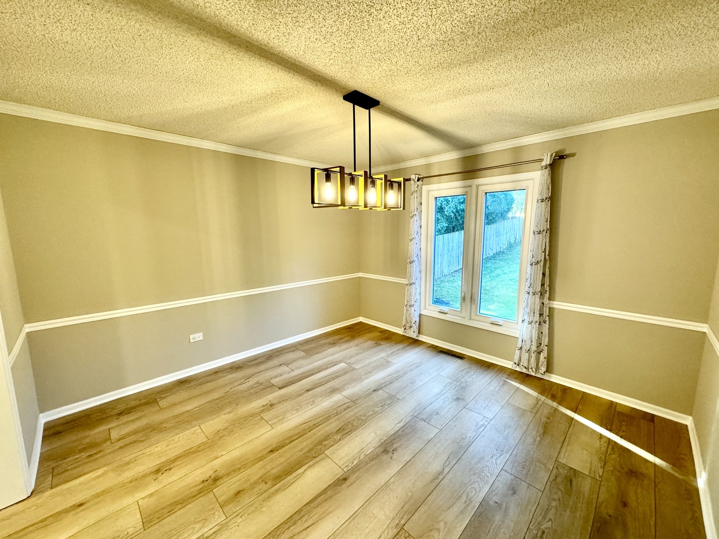 1398 East Gartner Road Naperville, IL 60540 - Photo 3 of 31 a view of an empty room with window and wooden floor