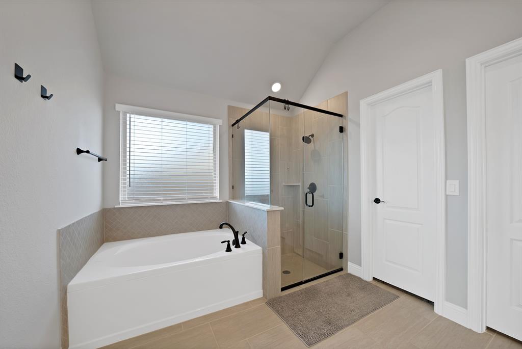 4054 Grove Valley Road Midlothian, TX 76065 - Photo 18 of 25 a bathroom with a bathtub and a shower