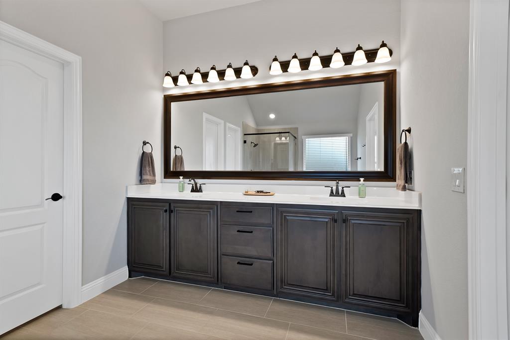 4054 Grove Valley Road Midlothian, TX 76065 - Photo 19 of 25 a bathroom with a double vanity sink and mirror