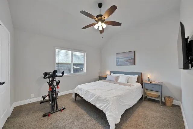a work room with furniture a flat screen tv and a window