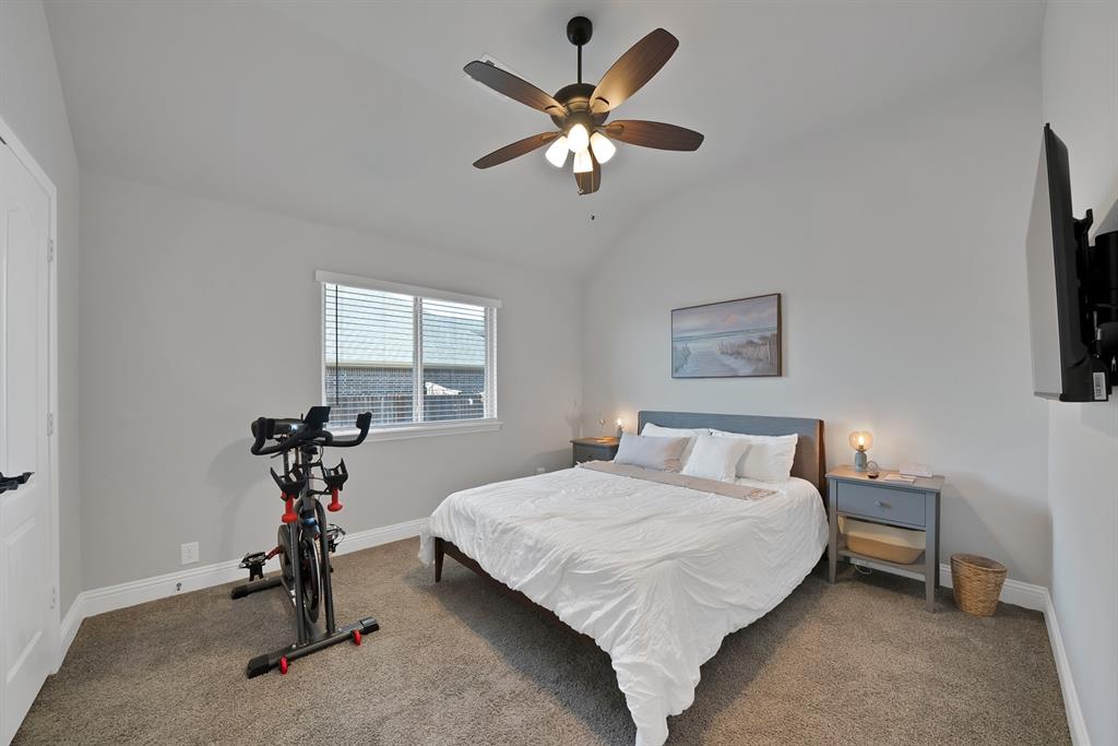 4054 Grove Valley Road Midlothian, TX 76065 - Photo 21 of 25 a bedroom with a bed and a chandelier