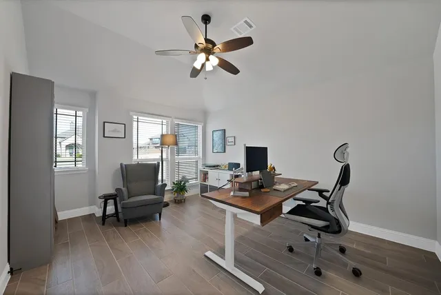 a work room with furniture and wooden floor