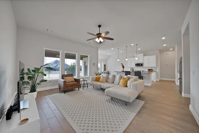 a living room with furniture and a large window