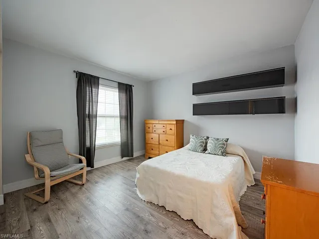 a bedroom with a bed and a chair