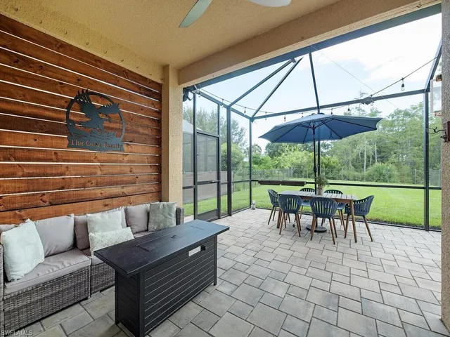 a view of a patio with a dining table and chairs