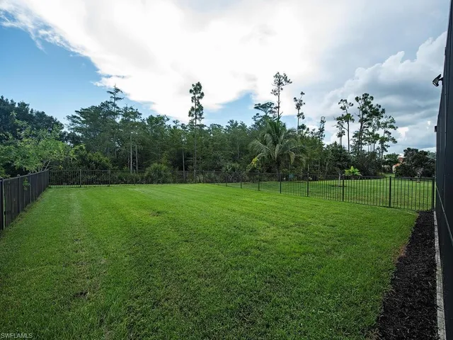 an aerial view of a house with a garden and lake view