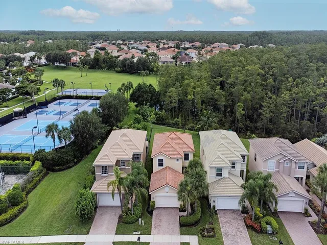 an aerial view of residential houses with outdoor space and swimming pool