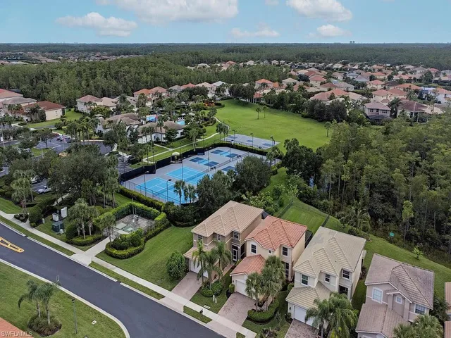 an aerial view of house with yard swimming pool and lake view