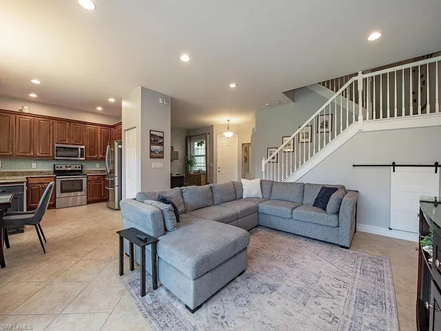 a living room with furniture and kitchen view