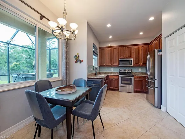 a kitchen that has a table and chairs in it