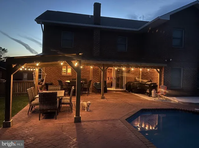 a view of a patio with table and chairs under an umbrella