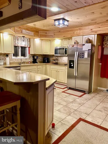 a kitchen with stainless steel appliances granite countertop a sink and cabinets