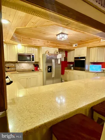 a view of a kitchen with a sink and microwave