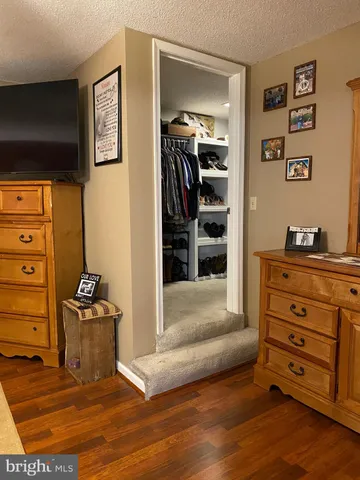 a bedroom with a bed and the view of cabinet