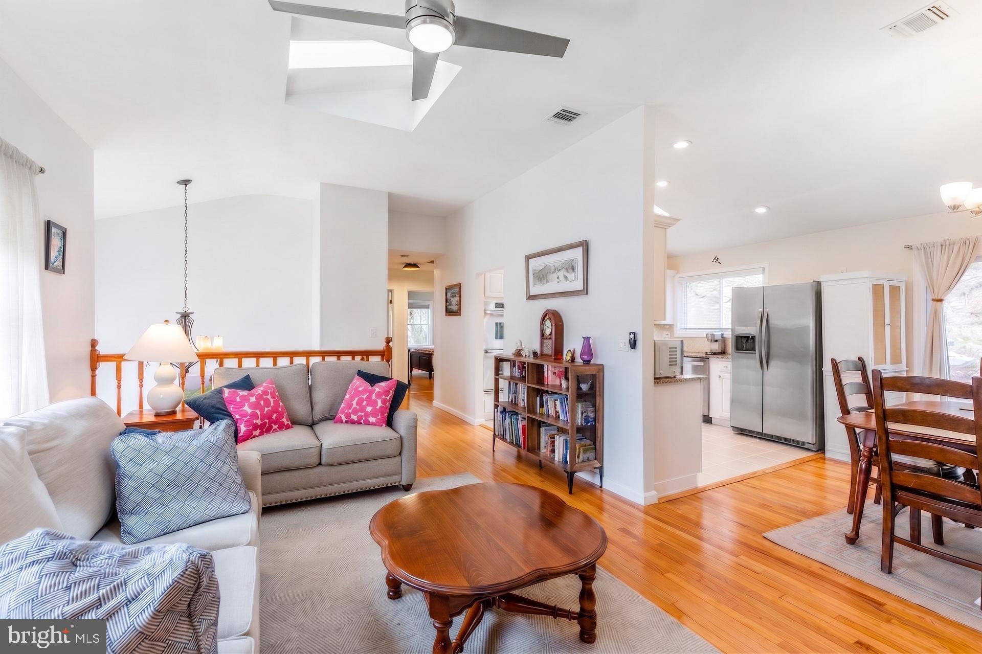 54 Highview Terrace Dover, NJ 07801 - Photo 15 of 35 a living room with furniture and a dining table with wooden floor