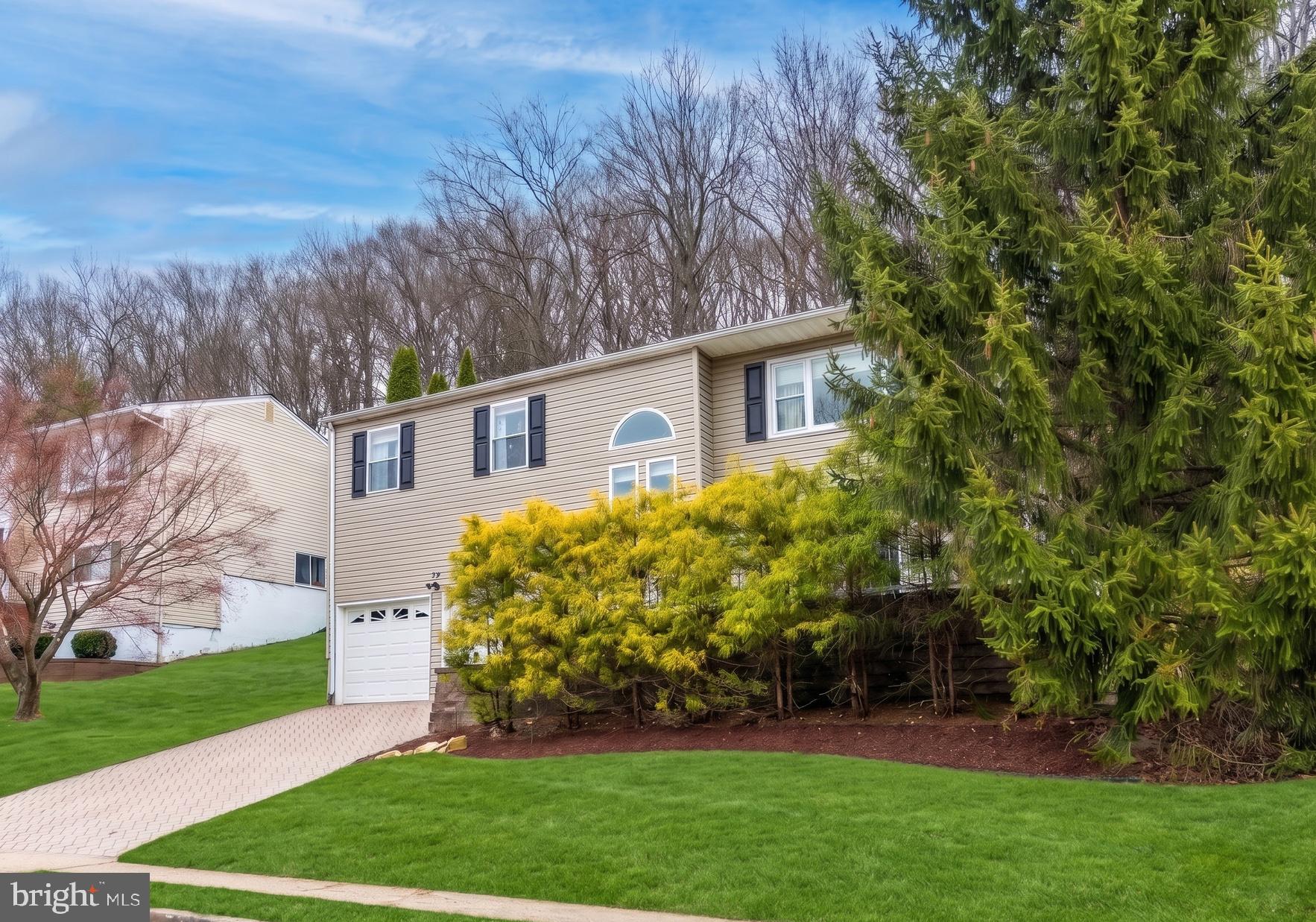 54 Highview Terrace Dover, NJ 07801 - Photo 32 of 35 a view of a white house next to a yard with big trees