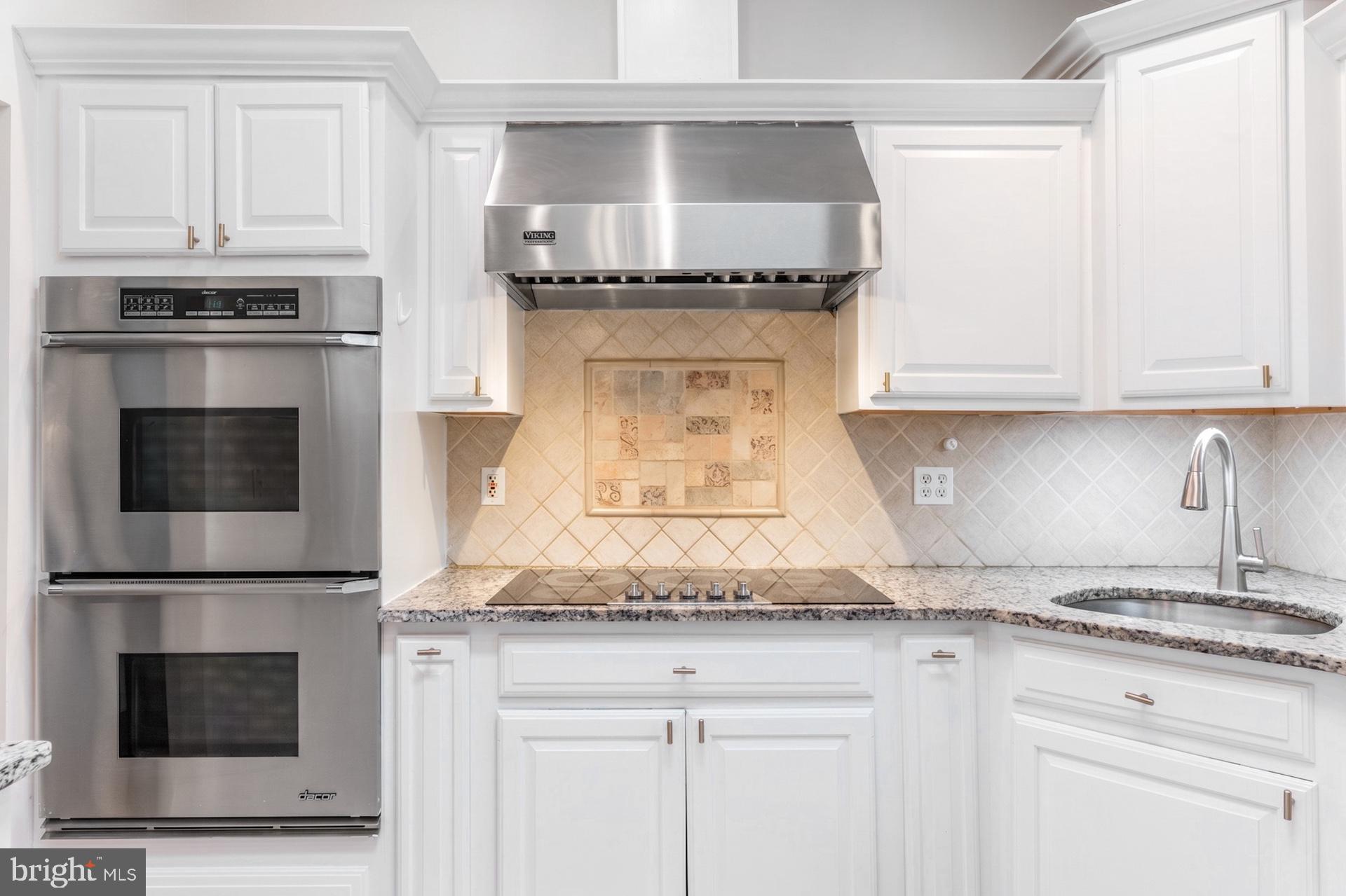 54 Highview Terrace Dover, NJ 07801 - Photo 8 of 35 a kitchen with granite countertop white cabinets and stainless steel appliances