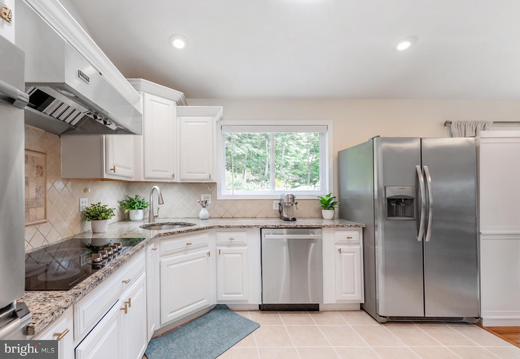 54 Highview Terrace Dover, NJ 07801 - Photo 10 of 35 a kitchen with stainless steel appliances granite countertop a sink a stove a refrigerator and white cabinets