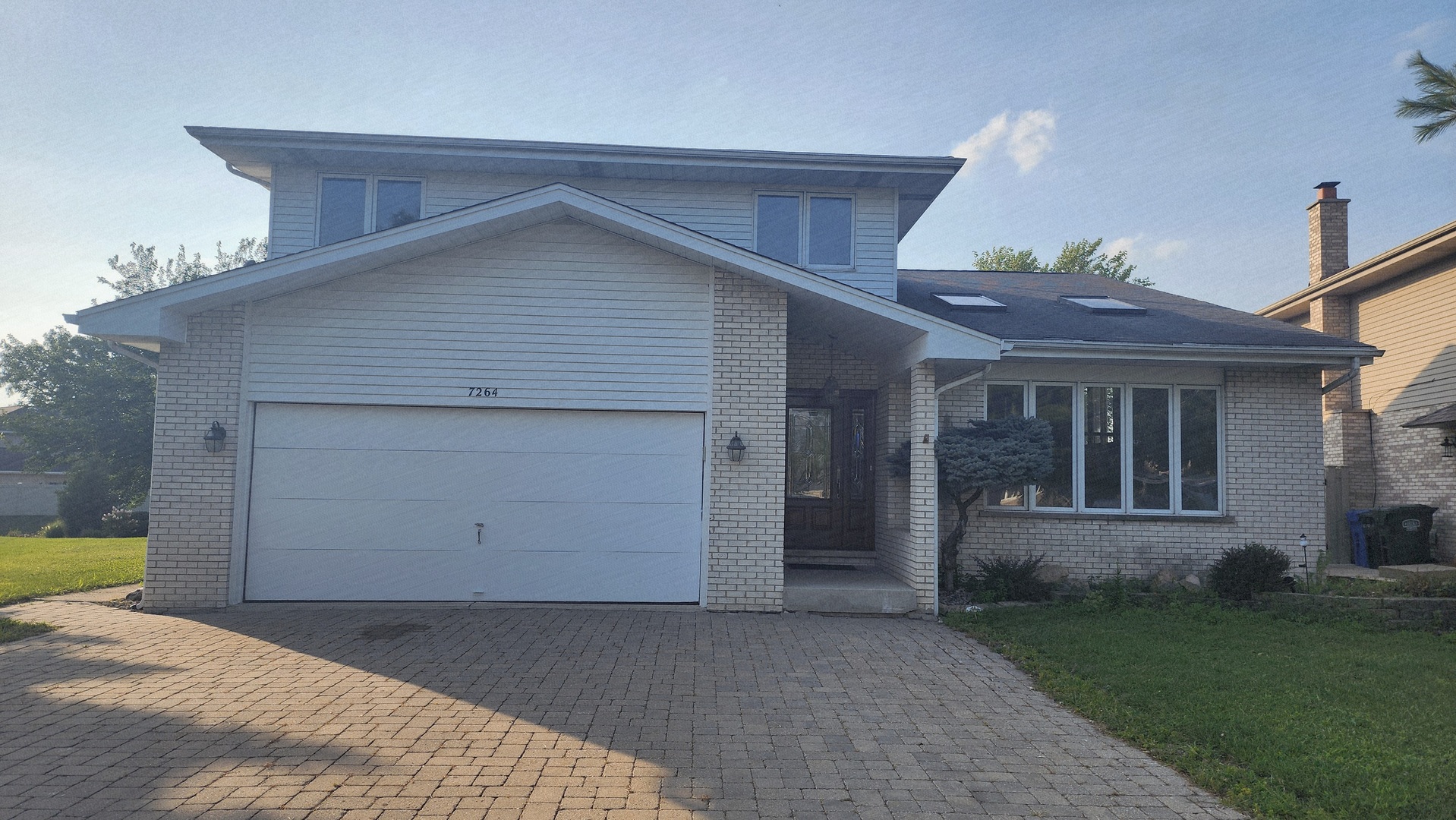 a view of a house with a yard and garage