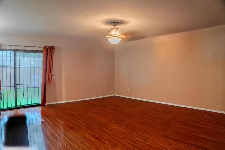 15610 Briar Spring Court Houston, TX 77489 - Photo 2 of 7 a view of a room with wooden floor fan and window