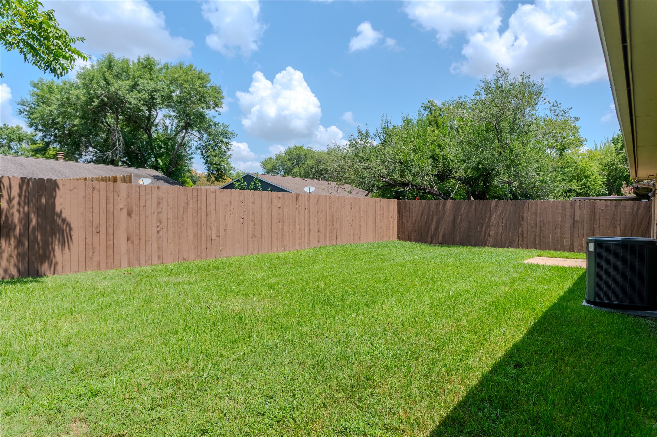 15610 Briar Spring Court Houston, TX 77489 - Photo 7 of 7 a view of a backyard with large trees and wooden fence