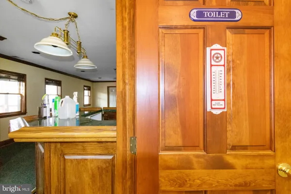a view of an empty room with a fireplace and wooden floor