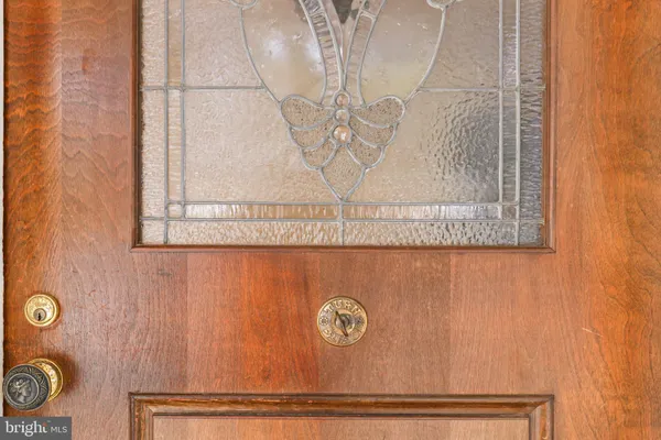 a view of an empty room with a fireplace wooden floor and a window