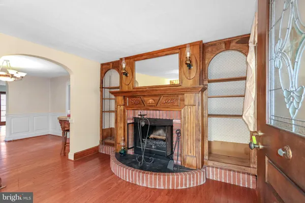 a living room with furniture a fireplace and large windows